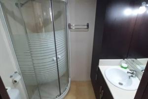 a bathroom with a glass shower and a sink at VORAMAR PORT XABIA in Jávea