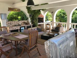 an outdoor living room with a table and chairs at Apartments Lorenandreja in Rab