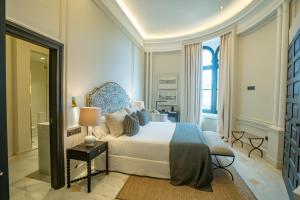 a bedroom with a bed and a large window at Soho Boutique Castillo de Santa Catalina - Adults Recommended in Málaga