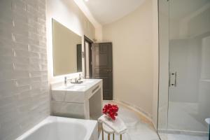 a white bathroom with a sink and a mirror at Soho Boutique Castillo de Santa Catalina - Adults Recommended in Málaga