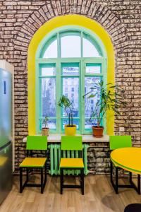 a room with a table and chairs and a window at Vorobey Hostel in Kyiv
