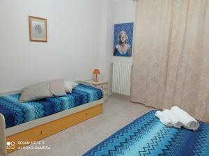 ein kleines Schlafzimmer mit zwei Betten und einem Fenster in der Unterkunft Taras holiday house in Taranto