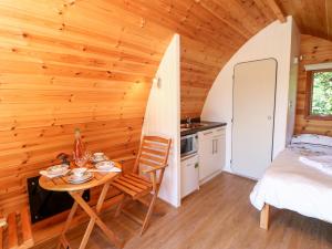 a room with a table and a bed and a kitchen at Lovesome Pod in Northallerton
