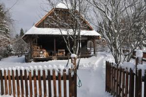 a log cabin in the snow with a fence at Chata Balówka in Cisna +12 photos