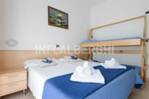 ein Schlafzimmer mit 2 Betten und Handtüchern darauf in der Unterkunft Hotel Nautilus in Bellaria-Igea Marina