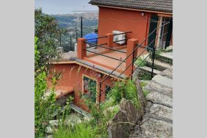 a red house with a balcony on the side of it at LA FINESTRA SUL GOLFO - CITRA 010018-LT-0033 - in Cogorno