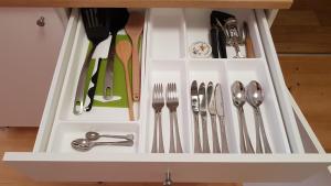 a white drawer with forks and spoons and utensils at Apartmán u Václava v centru města in Litomyšl