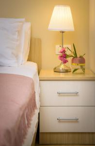 a bedroom with a bed and a lamp on a night stand at Lavica Seaside Apartments, Podstrana in Podstrana