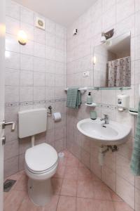 a bathroom with a toilet and a sink at Lavica Seaside Apartments, Podstrana in Podstrana