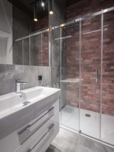 a bathroom with a sink and a shower at Luxo apartments 14 in Jelenia Góra