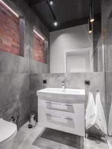 a bathroom with a white sink and a toilet at Luxo apartments 14 in Jelenia Góra