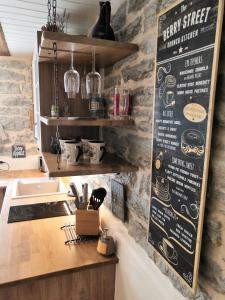 a kitchen with a menu on a brick wall at Like Home Apartments Salme 31 in Tallinn