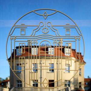 a building in the reflection of a glass orb at Hotel Liberte 33 BW Premier Collection in Poznań
