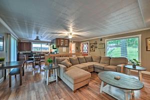 a living room with a couch and a table at Lake Barkley Home Private Dock, Kayaks, Fire Pit! in Cadiz