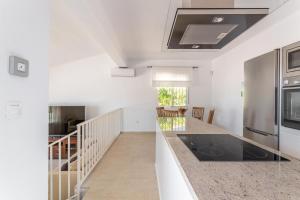 a kitchen with white walls and a counter top at Casa Vistas Axarquia in Vélez-Málaga