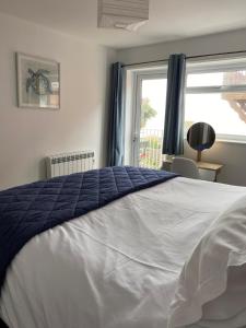 Un dormitorio con una cama grande y una ventana en Vitamin Sea with a Sea View and Parking, en Lyme Regis