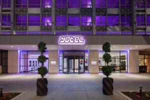 a building with a lit up sign in front of it at YOTEL Washington DC in Washington