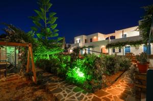a house with a garden at night at Agios Prokopios Hotel in Agios Prokopios