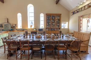 a large dining room with a table and chairs at The Old Cowshed in Kidwelly