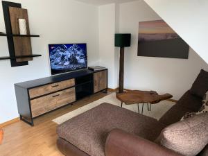 a living room with a couch and a flat screen tv at Ferienwohnung "drei Burgen Blick" in Sankt Goar