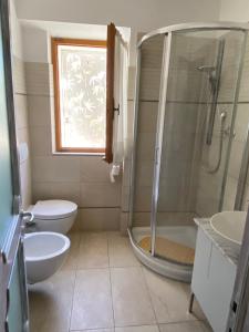 a bathroom with a shower and a toilet and a sink at Antistress Affittacamere in Osimo