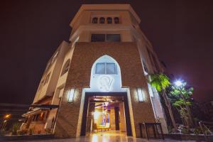 a building with a clock on it at night at Ocean Atlantic View (Ex Bo Hotel) in Agadir