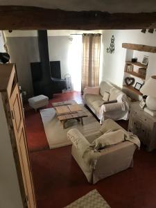 a living room with a couch and a coffee table at La Charmeuse in Céreste