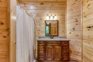 a bathroom with a sink and a mirror at City View Chalet in Gatlinburg