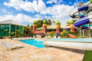 a pool at a resort with a water slide at Thermas All Inclusive Resort Poços de Caldas in Poços de Caldas