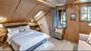 a bedroom with a bed in a room with wooden walls at Villa Zollhaus Bed & Breakfast in Türkheim