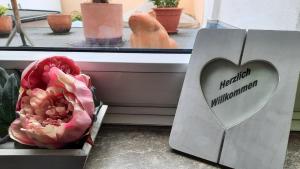 a box with a heart on it next to a flower at Hotel Merlin in Cologne
