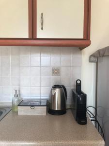 a kitchen counter with a coffee maker and a toaster at Stergios_Apartments 03 in Kozani