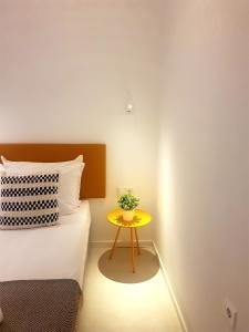 a bedroom with a yellow table next to a bed at ibis Styles Golden Sands Roomer Hotel in Golden Sands