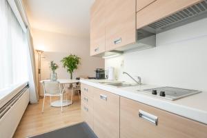 a kitchen with a sink and a table at Theaterstudio 1 Antwerp in Antwerp