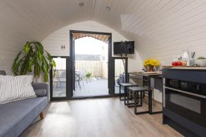 a kitchen and living room with a couch and a table at Harbour Hideaway in Newlyn