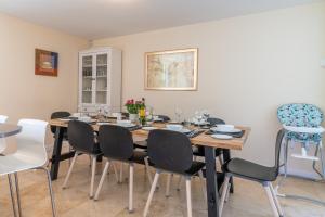 a dining room with a wooden table and chairs at Hill View Rise in Chipping Campden +17 photos