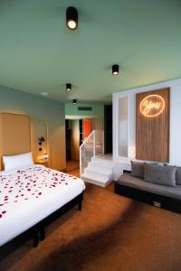 a hotel room with a bed and a sign on the wall at You Hotels Deauville - Handwritten Collection in Deauville