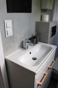 a white sink in a bathroom with at Domek Nad Zalewem in Gołdap