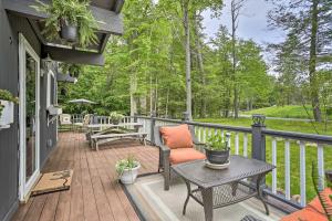 a patio with a table and chairs on a deck at Deck and Pool Access Welcoming Poconos Retreat in Tobyhanna