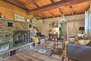 a living room with a large stone fireplace at Deck and Pool Access Welcoming Poconos Retreat in Tobyhanna