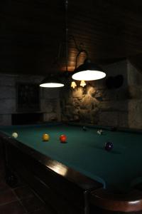 a room with a pool table with balls on it at Casa Aido Santo in Pinheiro de Lafões