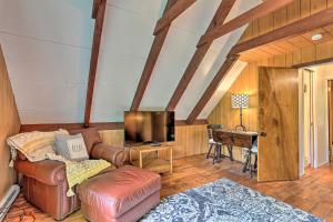 a living room with a couch and a tv at Deck and Pool Access Welcoming Poconos Retreat in Tobyhanna