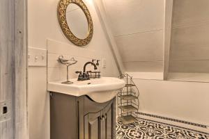 a bathroom with a sink and a mirror on the wall at Deck and Pool Access Welcoming Poconos Retreat in Tobyhanna +37 photos