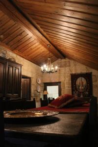 a bedroom with a bed and a chandelier at Casa Aido Santo in Pinheiro de Lafões