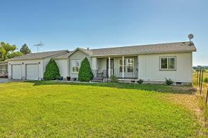 a house with a lawn in front of it at Rural Rigby Family Home with Yard Hike, Boat and Ski! in Lorenzo