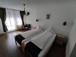 a bedroom with a large bed in a room at Hotel Restaurant Jungfrau in Lauterbrunnen