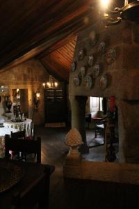 a living room with a stone fireplace in a house at Casa Aido Santo in Pinheiro de Lafões