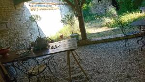 a wooden table and chairs in a yard at Fig Tree Barn in Gibourne