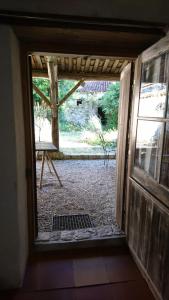 an open door with a view of a yard at Fig Tree Barn in Gibourne