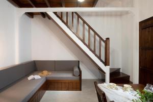 a living room with a couch and a staircase at Bosporus Apartments in Sarti